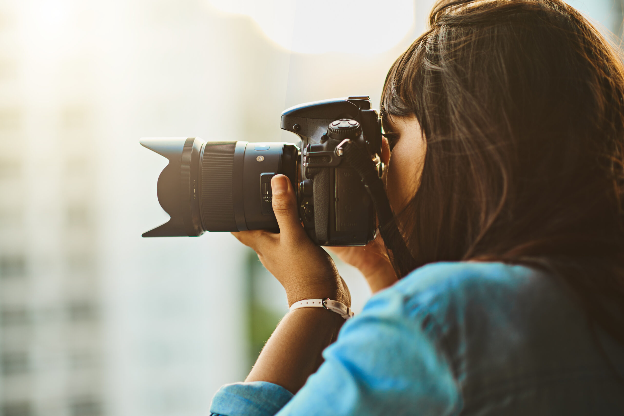 Shot of a woman taking pictures with her camera outside